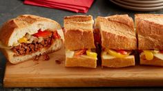 a cut in half sandwich sitting on top of a cutting board