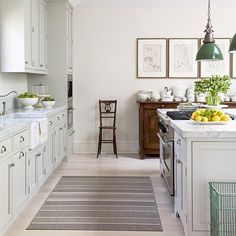 the kitchen is clean and ready to be used for cooking or eating, with white cabinets and wood flooring