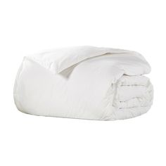 a white comforter is laying on top of a bed with the cover pulled up