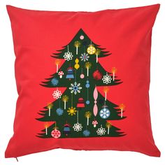 a red pillow with a christmas tree on it