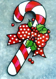 a candy cane with holly and bow on it's side in the middle of snow