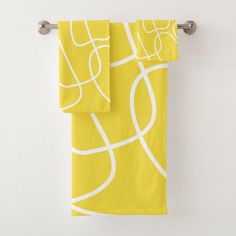 two yellow towels hanging on the wall next to each other with white lines painted on them