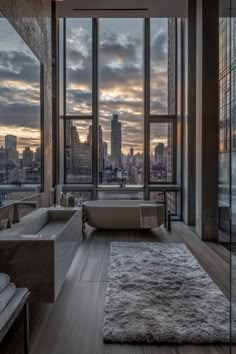 a bathroom with a bathtub, sink and large windows overlooking the city at sunset