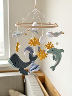 a baby crib mobile with sea animals hanging from it