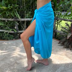 Crisp & Fresh    Introducing the simple 'Island Blue Cotton' sarong by Sarong Hut. This chic sarong, made from super soft cambric cotton, features a sleek, all-blue design with no tassels or fringe for a modern, minimalist look. Meticulously stitched at each end, it's a versatile and timeless addition to your travel essentials, offering both style and comfort for your beach adventures and beyond. Quick Dry Cool Touch Buttery Soft 100% Cotton Breathable Fabric No Fringe Compact for Travel Size 180cm x 110cm Blue Wrap Sarong For The Beach, Blue Wrap Sarong For Beach, Blue Cotton Sarong For Beachwear, Blue Cotton Sarong For Vacation, Island Blue, Beach Adventure, Blue Island, Women's Cover Up, Swimwear Cover Ups