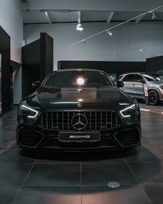 the front end of a mercedes car in a showroom