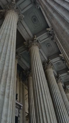 an old building with many pillars in it's center and the ceiling is painted white