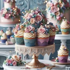 there are many cupcakes that are on the cake stand and decorated with flowers