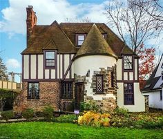 a large house with a turret roof in the middle of a yard