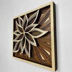 a wooden wall hanging with an intricate design on it