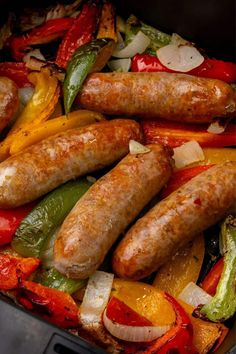 sausages and peppers are cooking in a pan