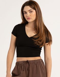 Tilly's V-Neck Rib Tee. V-Neckline. Rib Knit Construction. Short Sleeves. Cropped Fit. 93% Polyester, 7% Spandex. Machine Wash. Imported. Model Is Wearing A Size Small. Model Measurements:height: 5'7" Bust: 32"waist: 24.5"hips: 36" | Tillys V-Neck Rib Tee Cropped V Neck Tee, Basic Fitted V-neck Top, Casual Stretch V-neck Crop Top, Casual V-neck Stretch Crop Top, Trendy Fitted V-neck Crop Top, Casual V-neck Fitted Top, Basic V-neck Stretch Crop Top, Black Seamless V-neck Top, Casual Fitted V-neck Top