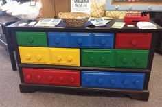 a multicolored chest of drawers with legos on top in a store display