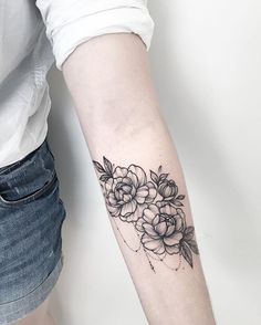 a woman's arm with flowers on it