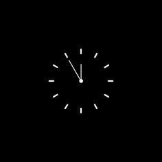 a black and white photo of a clock on a dark background with the time at 11 00