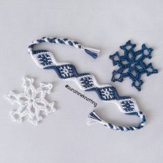 two snowflakes, one blue and the other white are next to each other