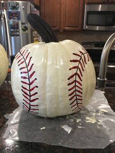 a baseball pumpkin sitting on top of a counter