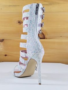 Wavy By Nelly Ice Glitter Adjustable functional strap and buckle detail. Back counter zipper closure. Cushioned Foot-Bed Heel: 4.5" Platform: 0.5" US Sizes Strap High Heels, Beaded Earrings Diy, Boots White, High Heels Shoes, Heels Shoes, Diy Earrings, Shoes Heels Boots, Shoes Boots, High Heel Shoes