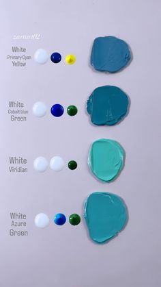 four different shades of blue, green and white paint arranged on a sheet of paper