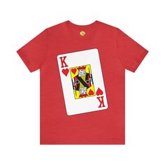 Step into the deck with our "King of Hearts" Big Face Tee. This eye-catching shirt features a bold illustration of the King of Hearts playing card, making it a standout choice for poker enthusiasts and card game lovers. Crafted from Bella Canvas 3001 fabric, it ensures both comfort and style. Elevate your wardrobe with this unique tee that combines a touch of royalty with the thrill of the game. Key Features: Made from Bella Canvas 3001 for softness. Striking King of Hearts illustration. Perfect Red Heart-shaped Top With Graphic Print, Valentine's Day Graphic Tee Shirt With Graphic Print, Red Graphic Print T-shirt For Valentine's Day, Valentine's Day Short Sleeve Shirt With Graphic Print, Valentine's Day Graphic Print Short Sleeve Shirt, Valentine's Day Graphic Print Tops, Playing Card Shirt, Queen Of Hearts Shirt, Hearts Illustration