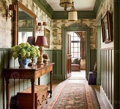 the hallway is decorated in green and white with floral arrangements on the table, along with an antique rug