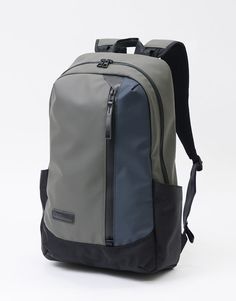 a gray and black backpack sitting on top of a white floor