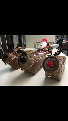 two brown bags sitting on top of a table next to santa clause's sleigh