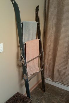 a towel rack in the corner of a bathroom