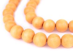 a necklace made out of wooden beads on a white background