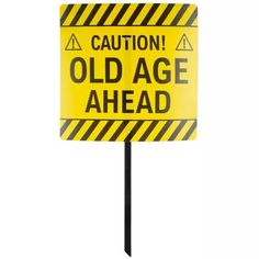 caution old age ahead sign on a black pole