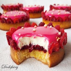 four desserts with raspberry filling and white frosting