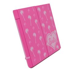 a pink notebook with palm trees and heart on the front, printed with barbie's name