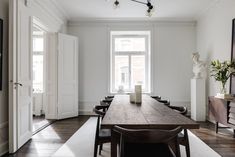 a long wooden table sitting in the middle of a room