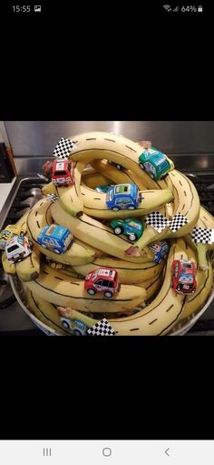 a bunch of bananas sitting on top of a stove with cars and trucks painted on them