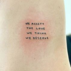 a person with a tattoo on their back saying we accept the love we think we observe