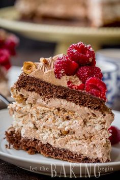 a piece of cake on a plate with raspberries