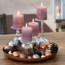 a candle holder filled with candles on top of a wooden table