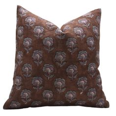 a brown pillow with blue flowers on it