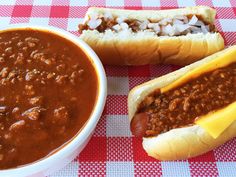 two chili dogs and a bowl of chili