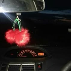 a car dashboard with an air freshener hanging from it