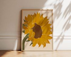 a sunflower is shown in front of a white wall with a shadow on the floor