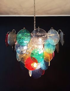 a multi colored chandelier hanging from a ceiling