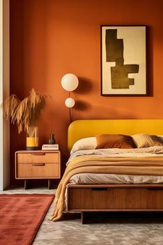 a bedroom with an orange wall and yellow bedding in the center, along with two lamps on either side of the bed