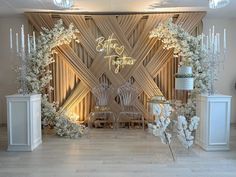 a decorated stage with white flowers and candles