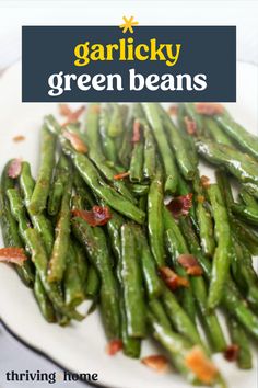 green beans on a white plate with bacon and text overlay that reads garlicky green beans