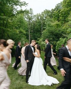 a bride and groom are surrounded by their wedding party