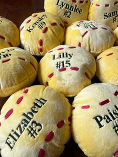 a pile of stuffed buns with names and date written on them for people to eat