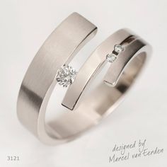 two wedding rings with one diamond in the middle