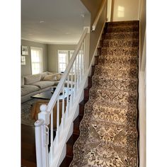 a carpeted staircase leading up to a living room