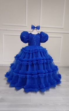 Celebrate in style with our Royal Blue Flower Girl Ball Gown! This exquisite dress is perfect for any special occasion, whether it's a wedding, birthday party, or princess-themed event. Made with attention to detail and a touch of magic, this baby blue princess dress will make your little one feel like royalty. The special design features a puffy tutu skirt that adds volume and flair, creating a truly enchanting look. Crafted with care and made for comfort, this dress is sure to be a hit with both parents and princesses alike. Order now and let your little one shine bright like a star. Kids Ball Gowns Princesses, Blue Fitted Tulle Dress, Fitted Blue Tulle Ball Gown, Blue Tulle Dress For Party, Blue Tulle Party Dress, Blue Tulle Princess Dress For Party, Fitted Blue Pageant Dress For Dress-up, Blue Gown For Dress-up, Blue Fitted Elegant Princess Dress